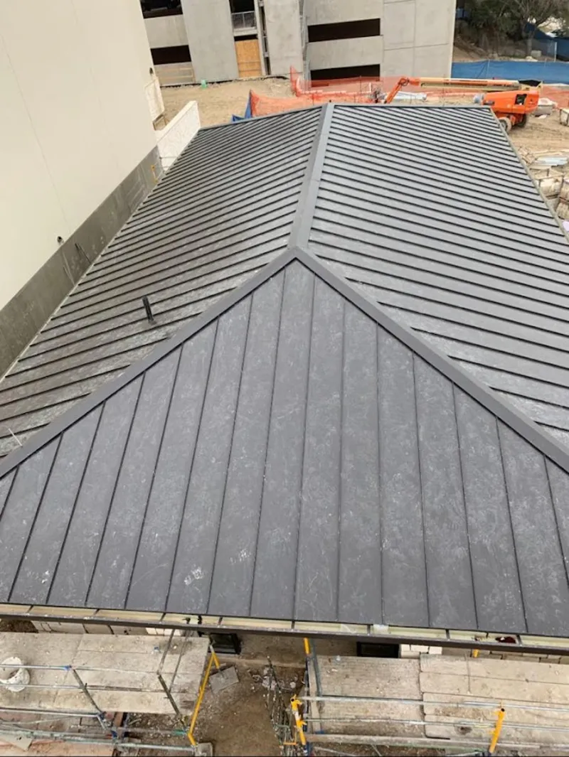 Commercial metal roof construction with crane equipment in Murraysville