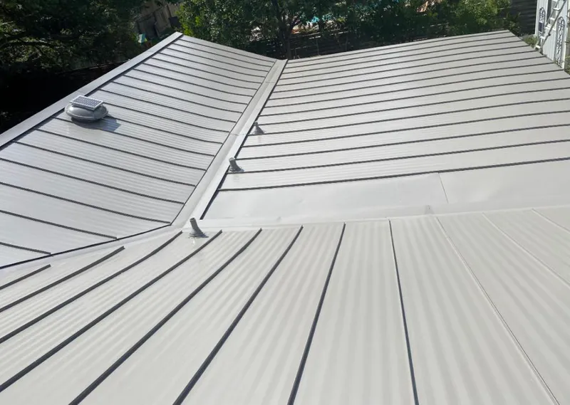 Solar attic fan installed on a metal roof for Roof Ventilation in Murraysville